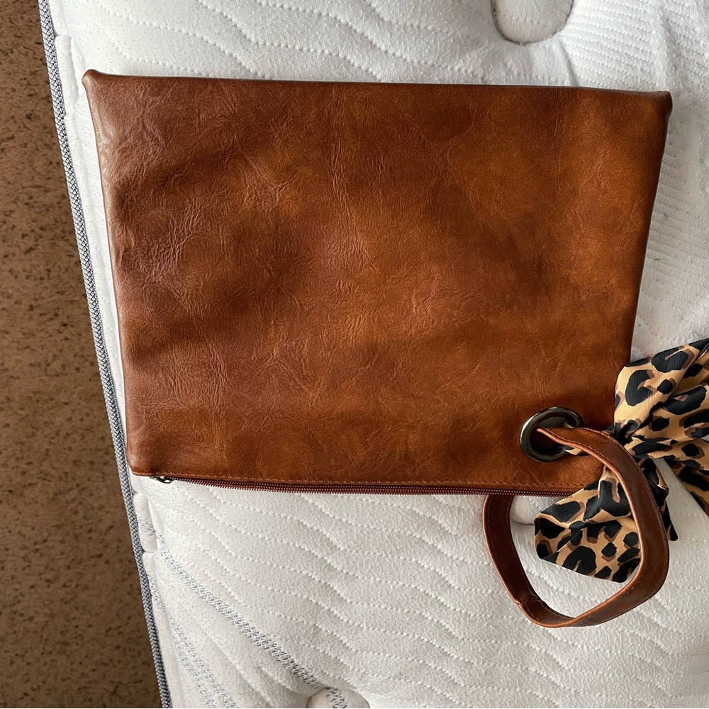 Wristlet with cheetah scarf.